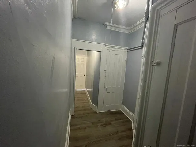 a view of a hallway with wooden floor