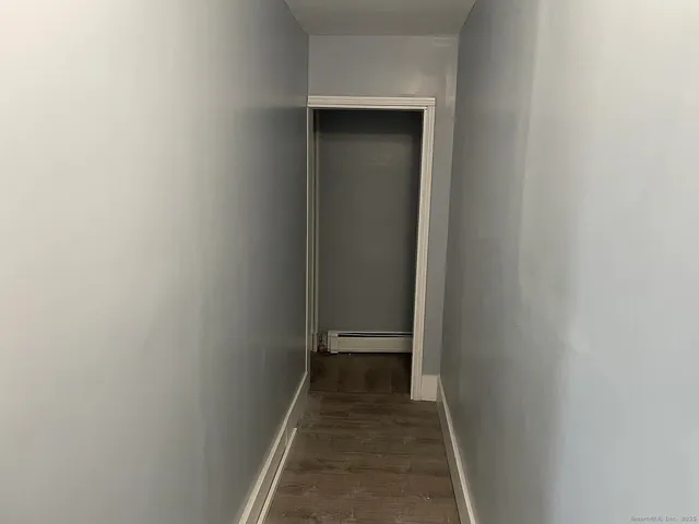 an empty room with wooden floor and closet