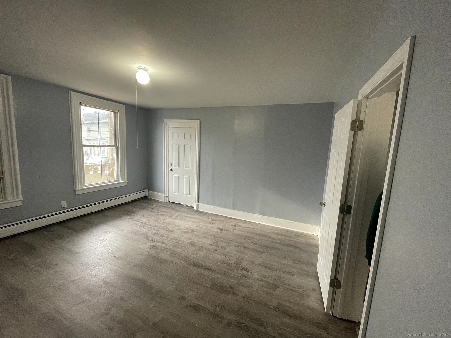 34 Park Street, Unit 1 Bridgeport, CT 06608 - Photo 7 of 8 an empty room with windows and closet