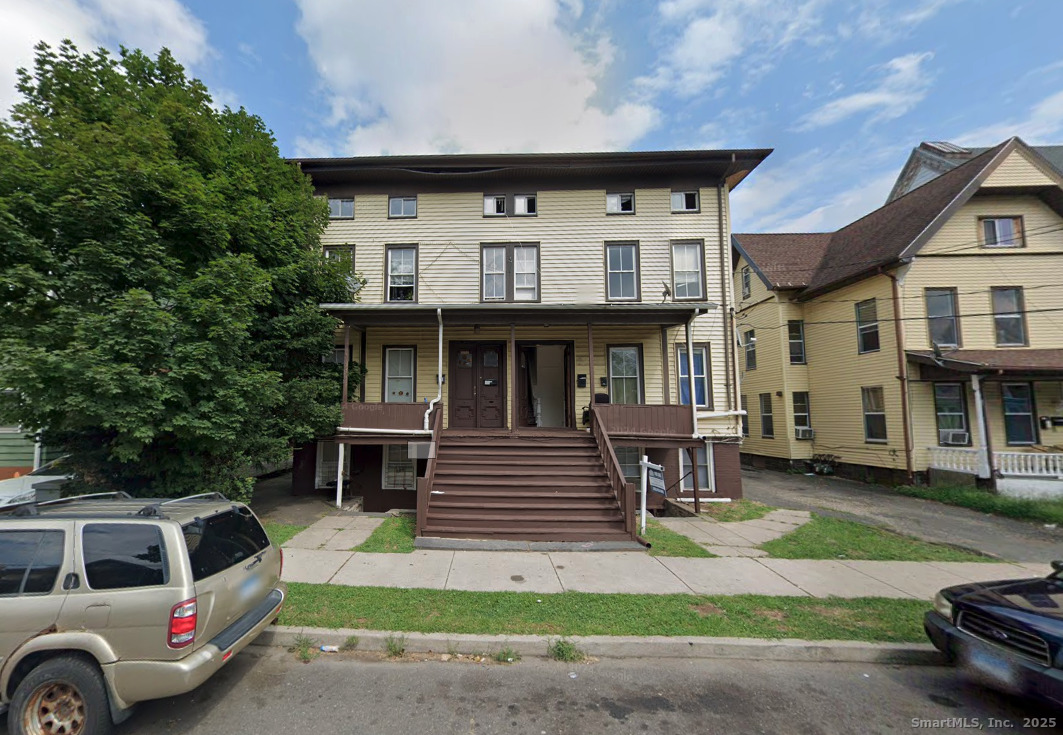 34 Park Street, Unit 1 Bridgeport, CT 06608 - Photo 8 of 8 a front view of a house with a yard