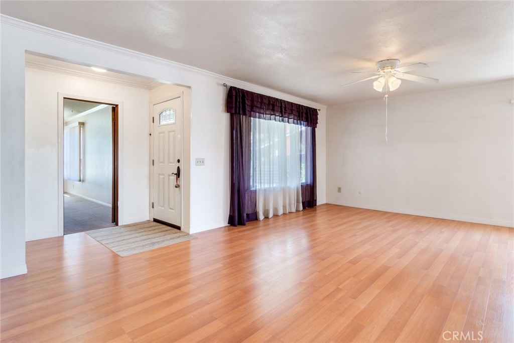 9130 Duncan Avenue Riverside, CA 92503 - Photo 4 of 34 a view of a livingroom with wooden floor and a ceiling fan