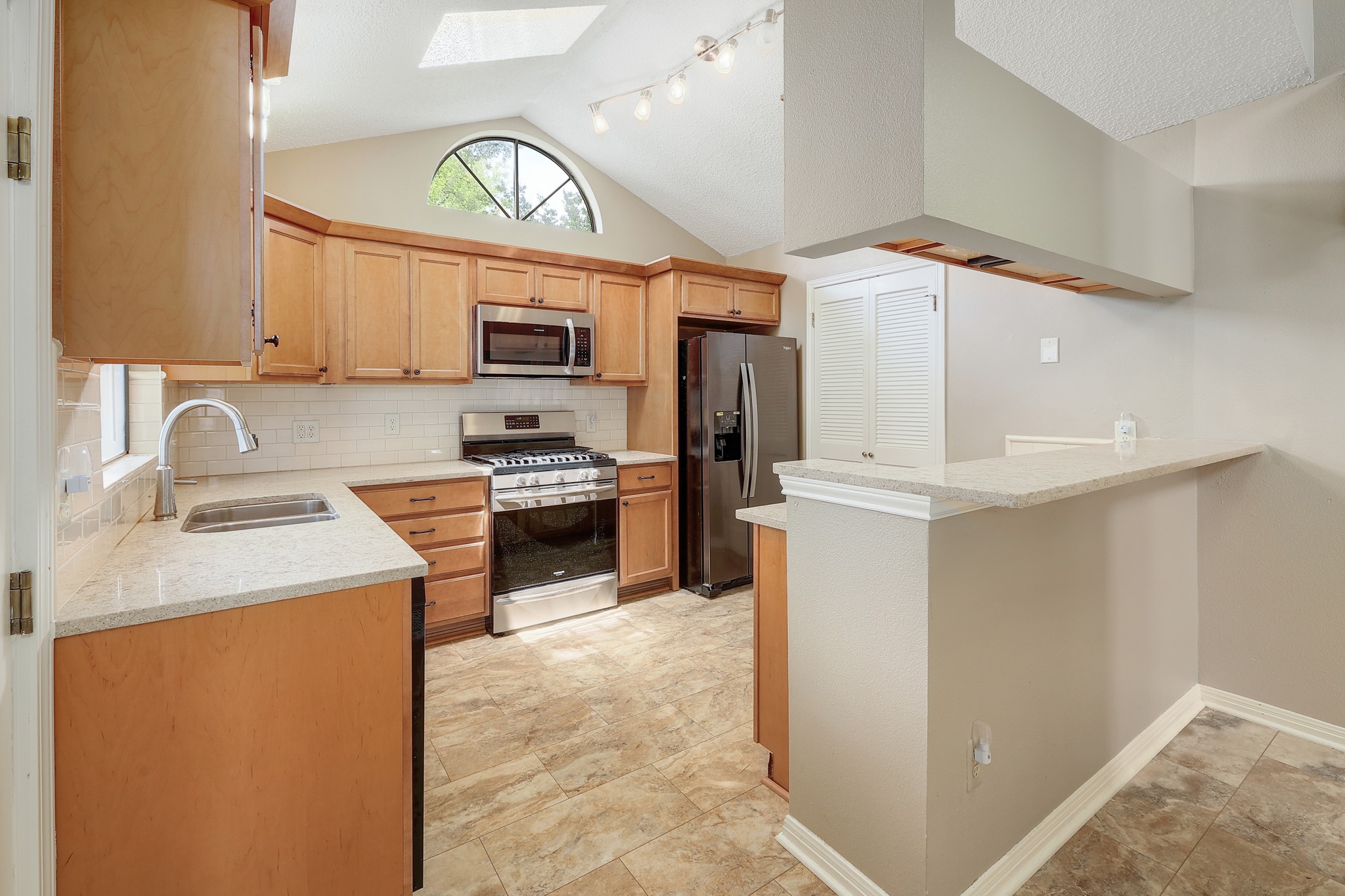 2202 Warfield Way Austin, TX 78728 - Photo 10 of 32 A well-appointed kitchen showcasing light wood cabinetry and stainless steel appliances.
