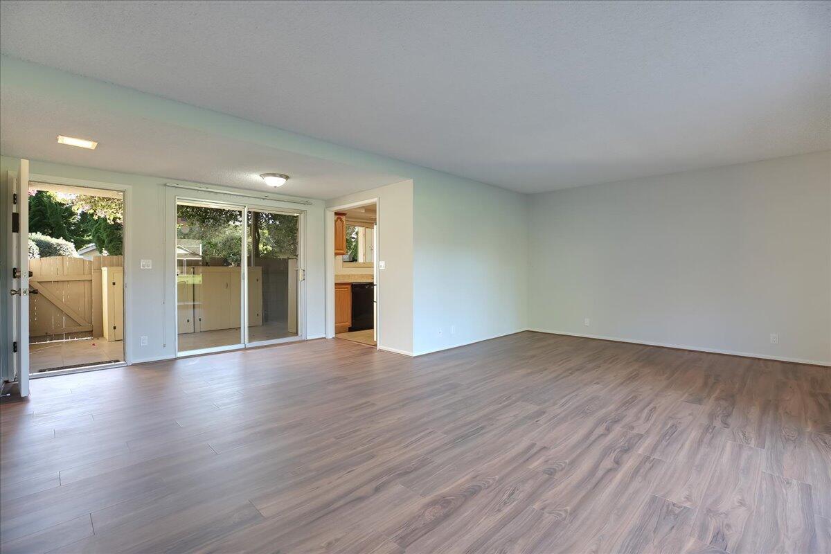 5910 Encina Road, Unit 3 Goleta, CA 93117 - Photo 22 of 45 a view of an empty room with wooden floor and a window