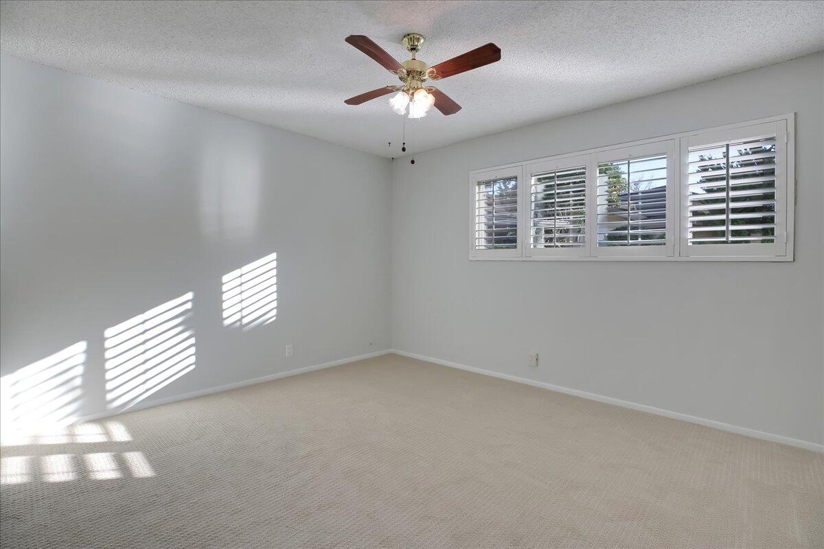 5910 Encina Road, Unit 3 Goleta, CA 93117 - Photo 24 of 45 an empty room with windows and ceiling fan
