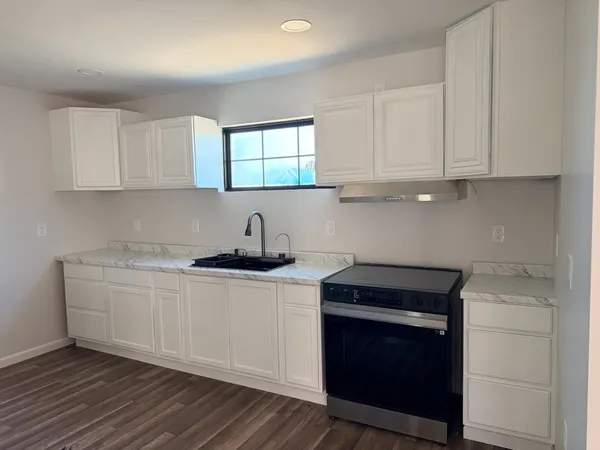 a room with wooden floor and window
