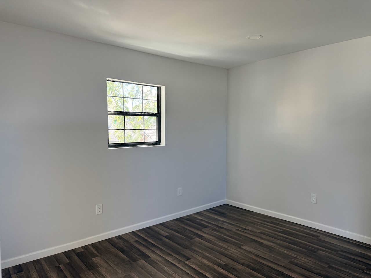 3512 Castor Street Houston, TX 77022 - Photo 17 of 24 an empty room with wooden floor and windows