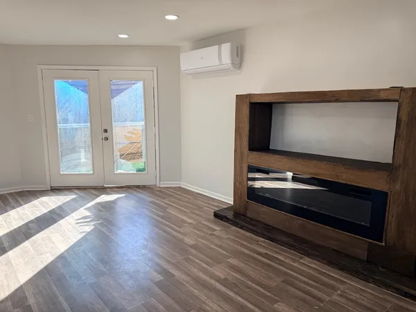 a view of a room with wooden floor