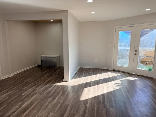 a view of kitchen with sink and refrigerator