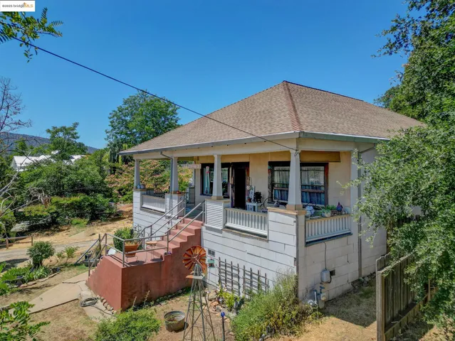 a view of a house with backyard porch and sitting area