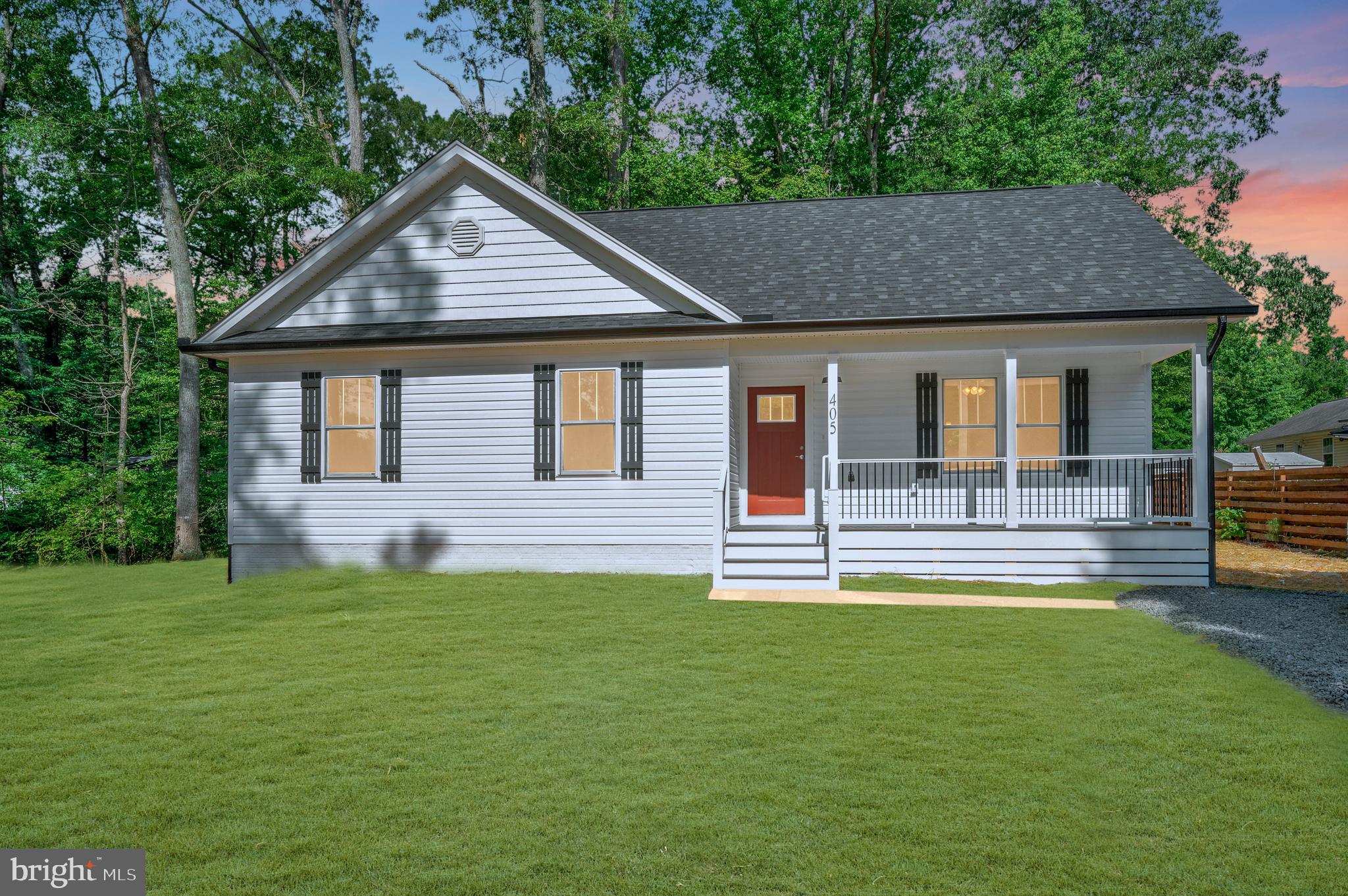 a house that has a big yard with wooden fence