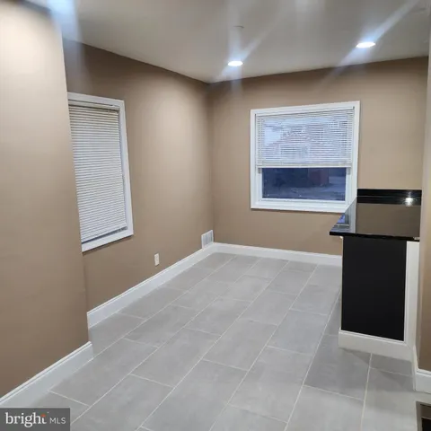 a white bath tub sitting next to a white sink and vanity