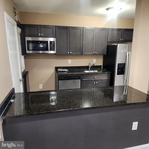 a view of room with wooden floor