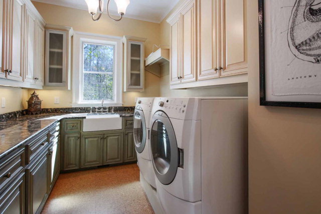 5291 Arkwright Road Macon, GA 31210 - Photo 14 of 24 a utility room with stainless steel appliances granite countertop a sink a washer and dryer next to a window
