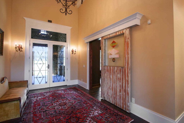 5291 Arkwright Road Macon, GA 31210 - Photo 3 of 24 a view of a hallway with a chandelier and glass door