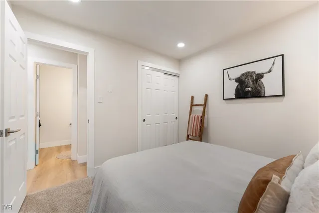 a bedroom with a bed and wall painting