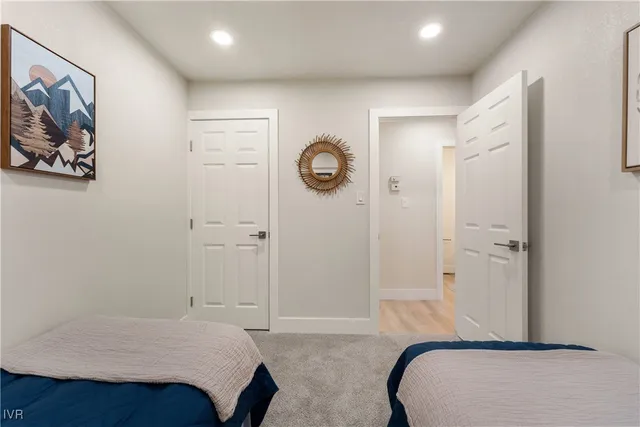 a bedroom with a bed and a painting on the wall