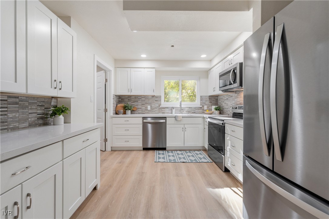 321 Ski Way, Unit 16 Incline Village, NV 89451 - Photo 4 of 23 a kitchen with white cabinets stainless steel appliances and window