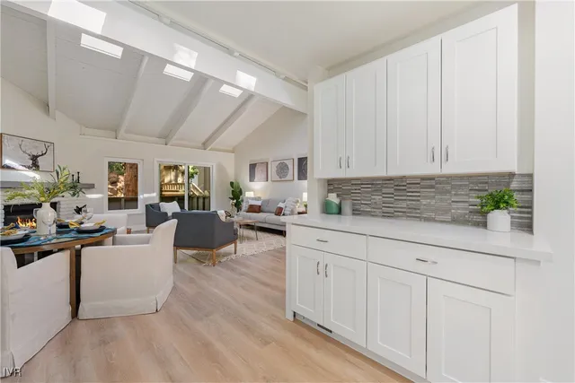 a kitchen with cabinets and wooden floor