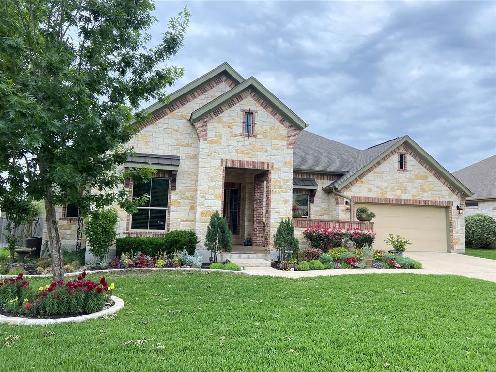 3216 Herradura Drive Cedar Park, TX 78641 - Photo 1 of 35 a front view of a house with a yard and potted plants
