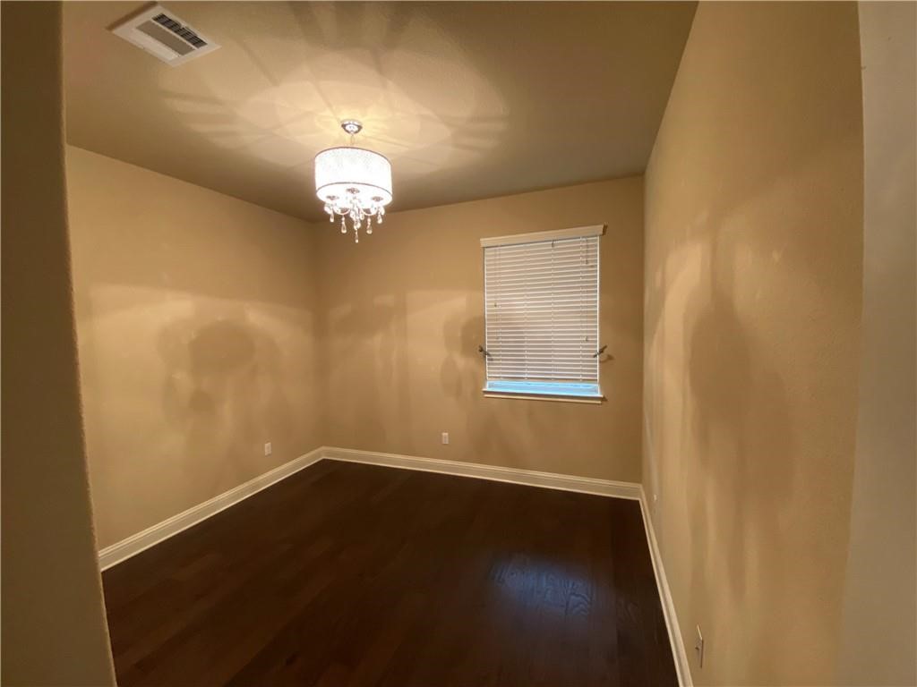 3216 Herradura Drive Cedar Park, TX 78641 - Photo 15 of 35 a view of a room with wooden floor chandelier and a window