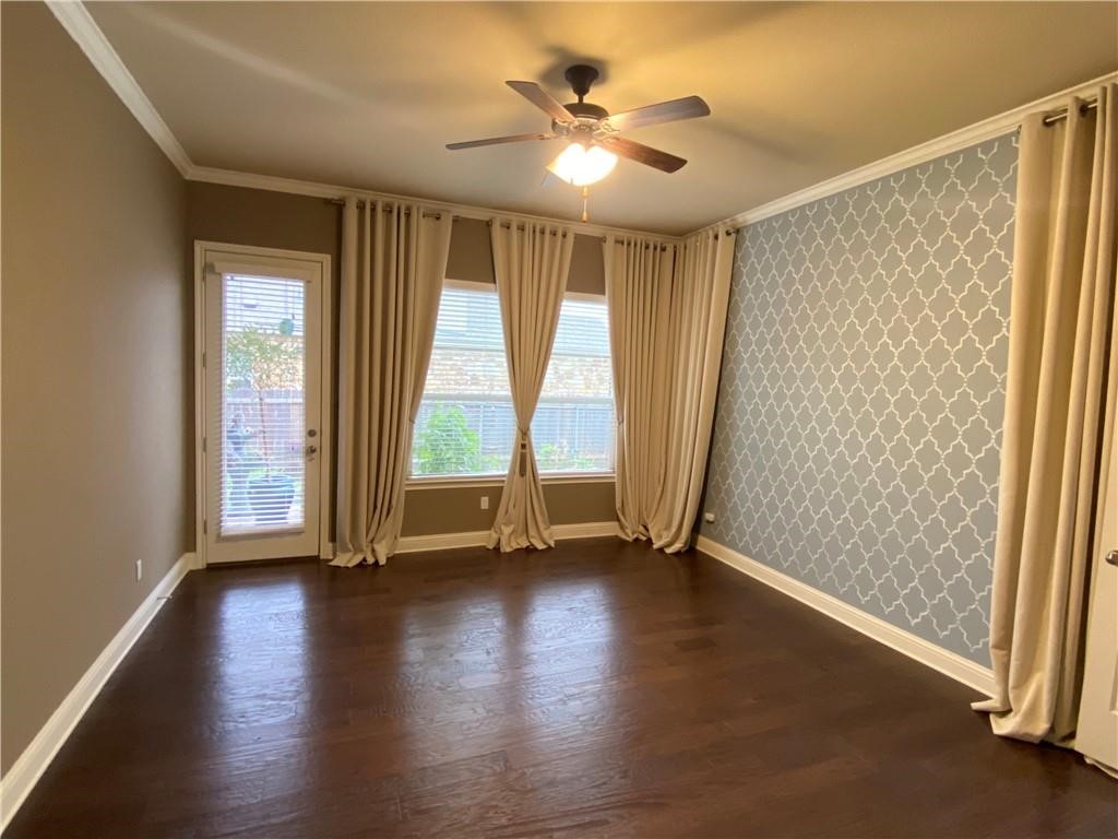 3216 Herradura Drive Cedar Park, TX 78641 - Photo 21 of 35 an empty room with wooden floor and windows with curtains