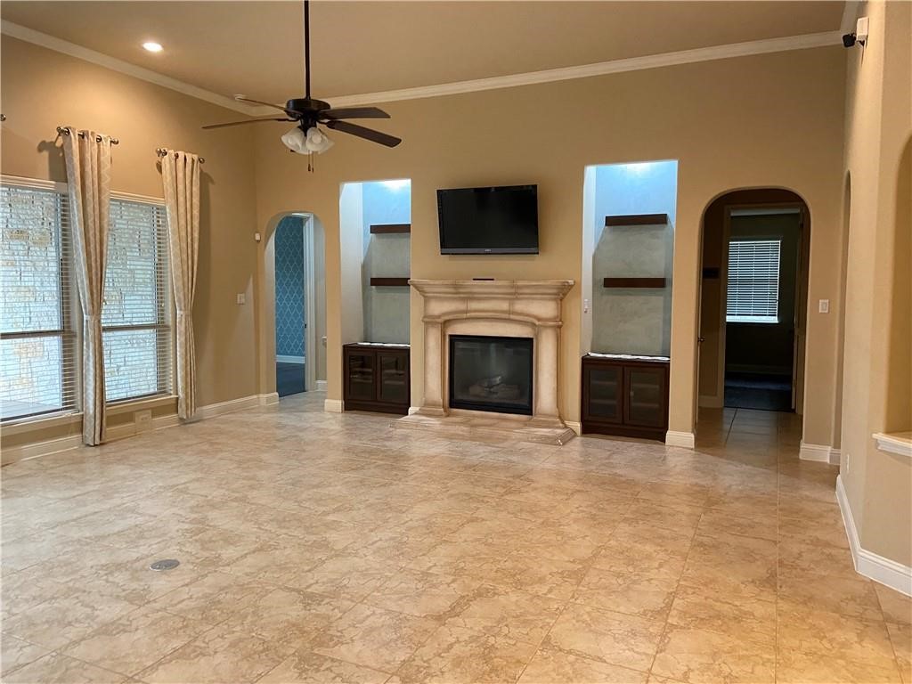 3216 Herradura Drive Cedar Park, TX 78641 - Photo 29 of 35 a view of an empty room with a fireplace and a ceiling fan
