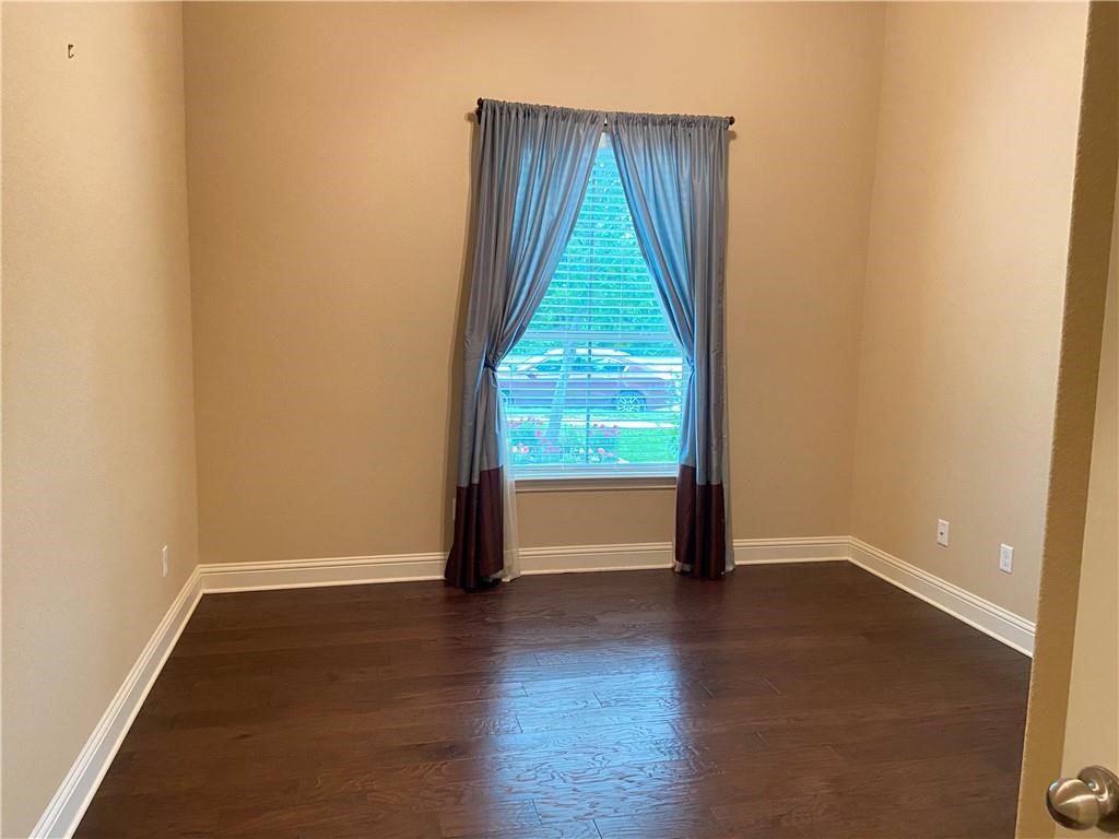 3216 Herradura Drive Cedar Park, TX 78641 - Photo 33 of 35 an empty room with wooden floor and windows