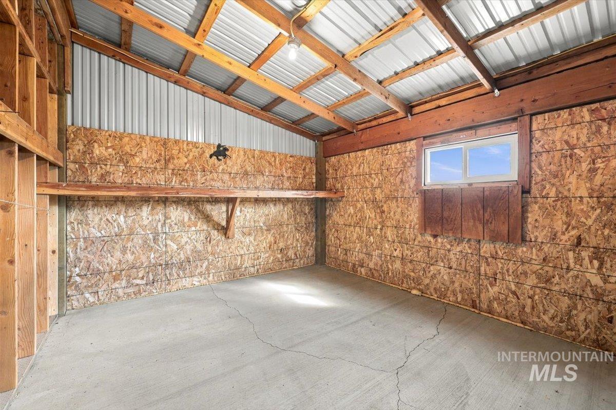 18026 Briar Creek Road Murphy, ID 83650 - Photo 39 of 50 Utility building with a corrugated metal roof, exposed wood framing, and a concrete floor