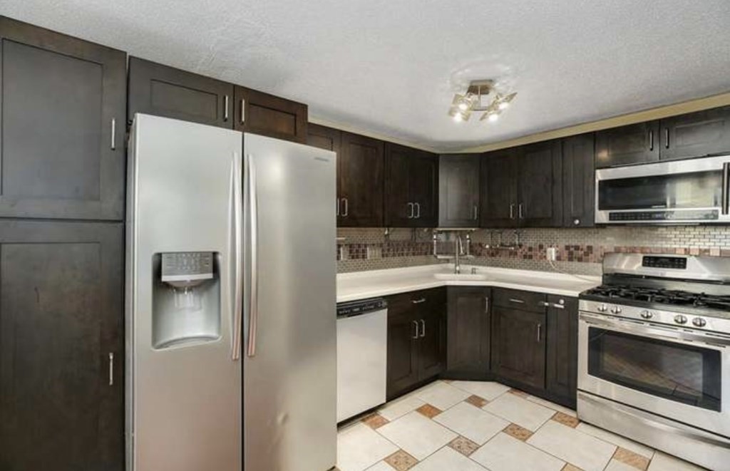 87 Meeting House Path, Unit 87 Ashland, MA 01721 - Photo 5 of 27 a kitchen with stainless steel appliances granite countertop a refrigerator stove a sink and dishwasher