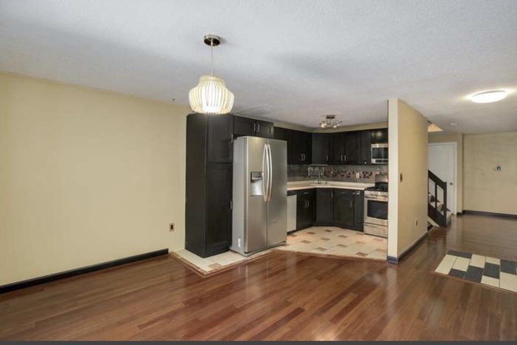 87 Meeting House Path, Unit 87 Ashland, MA 01721 - Photo 6 of 27 a kitchen with stainless steel appliances kitchen island granite countertop a refrigerator and a stove top oven