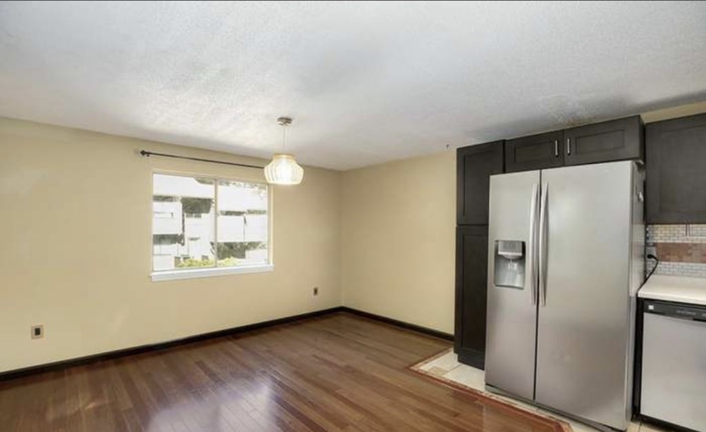 87 Meeting House Path, Unit 87 Ashland, MA 01721 - Photo 7 of 27 a view of an empty room with wooden floor and a window