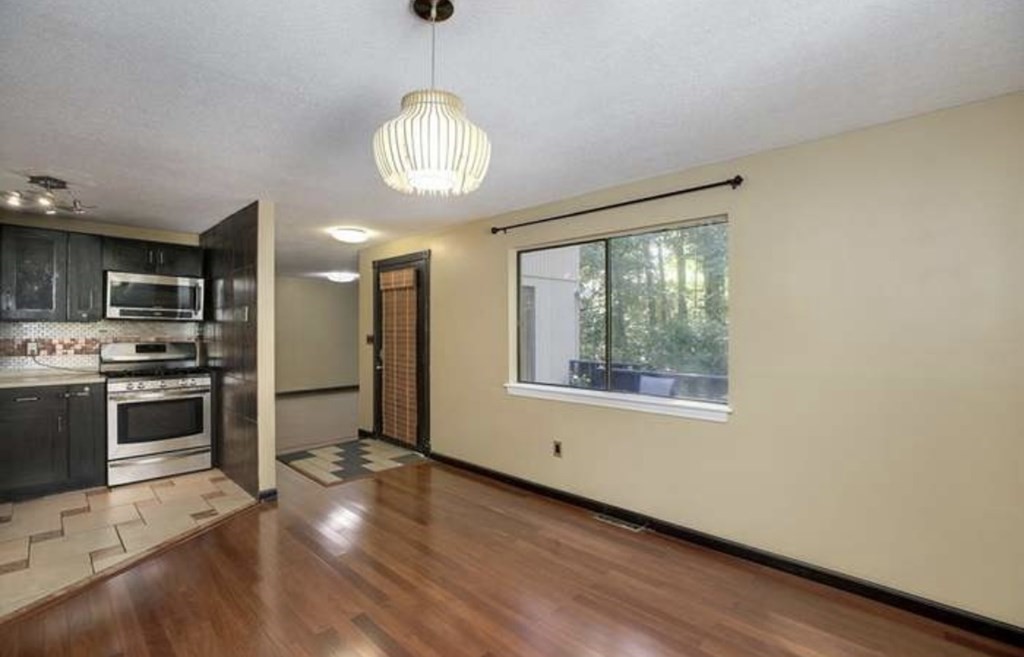 87 Meeting House Path, Unit 87 Ashland, MA 01721 - Photo 8 of 27 a view of a kitchen with stainless steel appliances wooden floor and a large window
