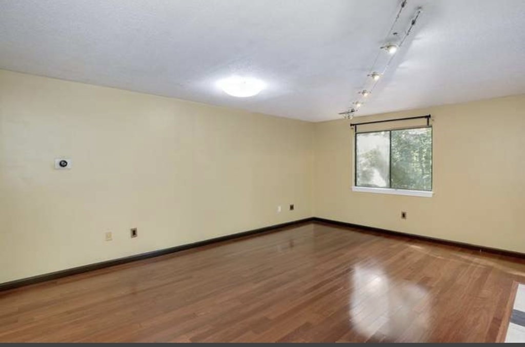 87 Meeting House Path, Unit 87 Ashland, MA 01721 - Photo 9 of 27 an empty room with wooden floor and windows
