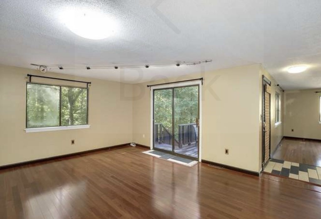 87 Meeting House Path, Unit 87 Ashland, MA 01721 - Photo 10 of 27 an empty room with wooden floor and windows