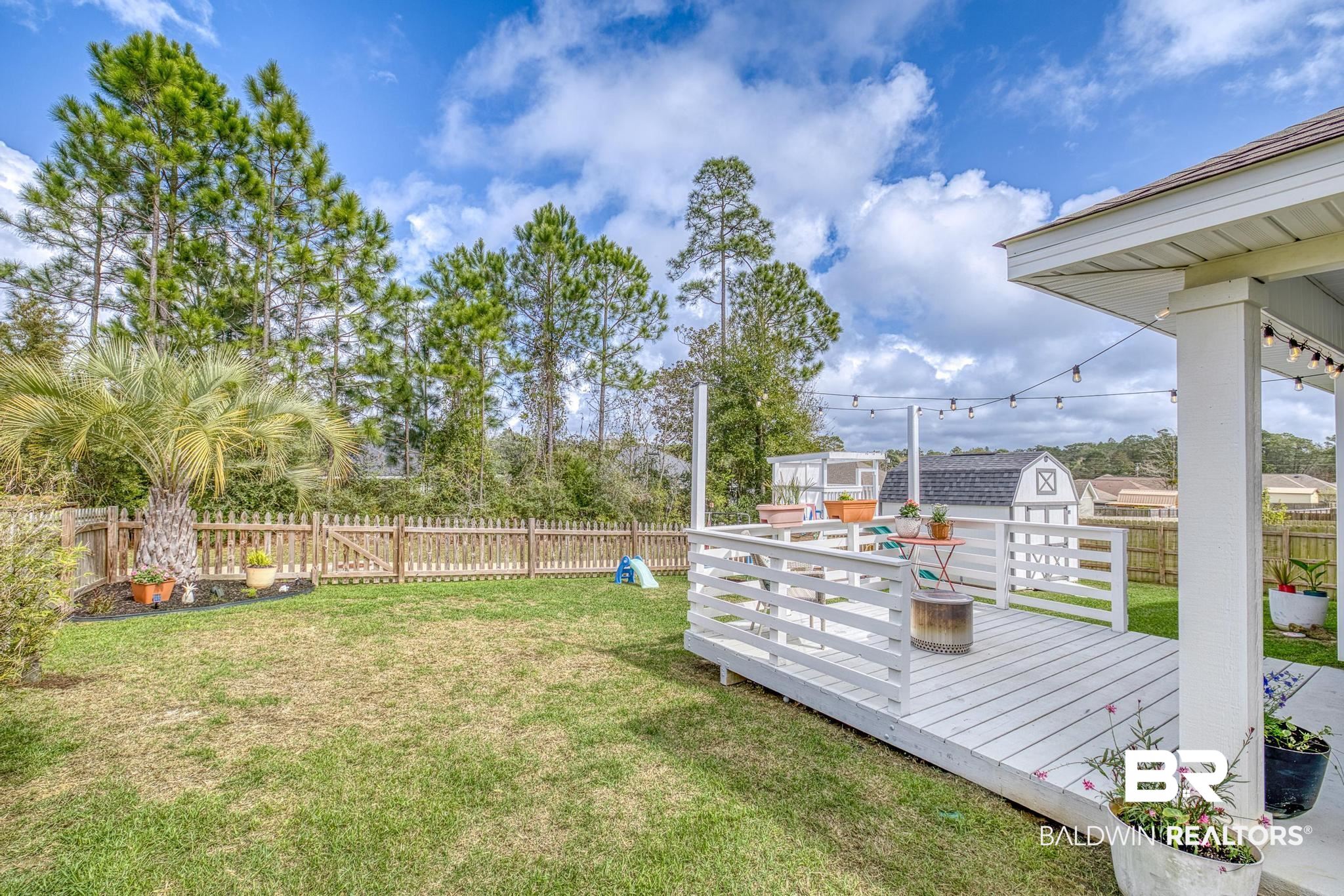 3078 Camino Real Loop Lillian, AL 36549 - Photo 27 of 51 Fenced backyard with a wooden deck