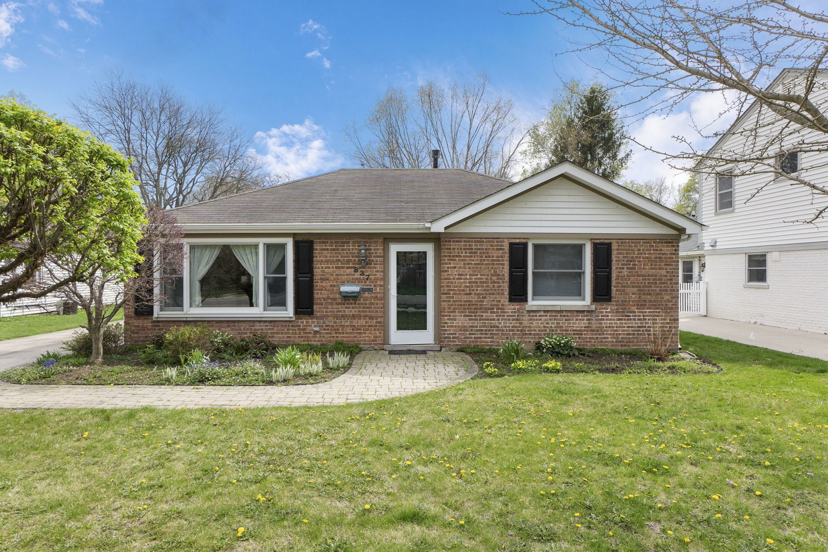 837 East Rockland Road Libertyville, IL 60048 - Photo 17 of 17 a front view of a house with a garden