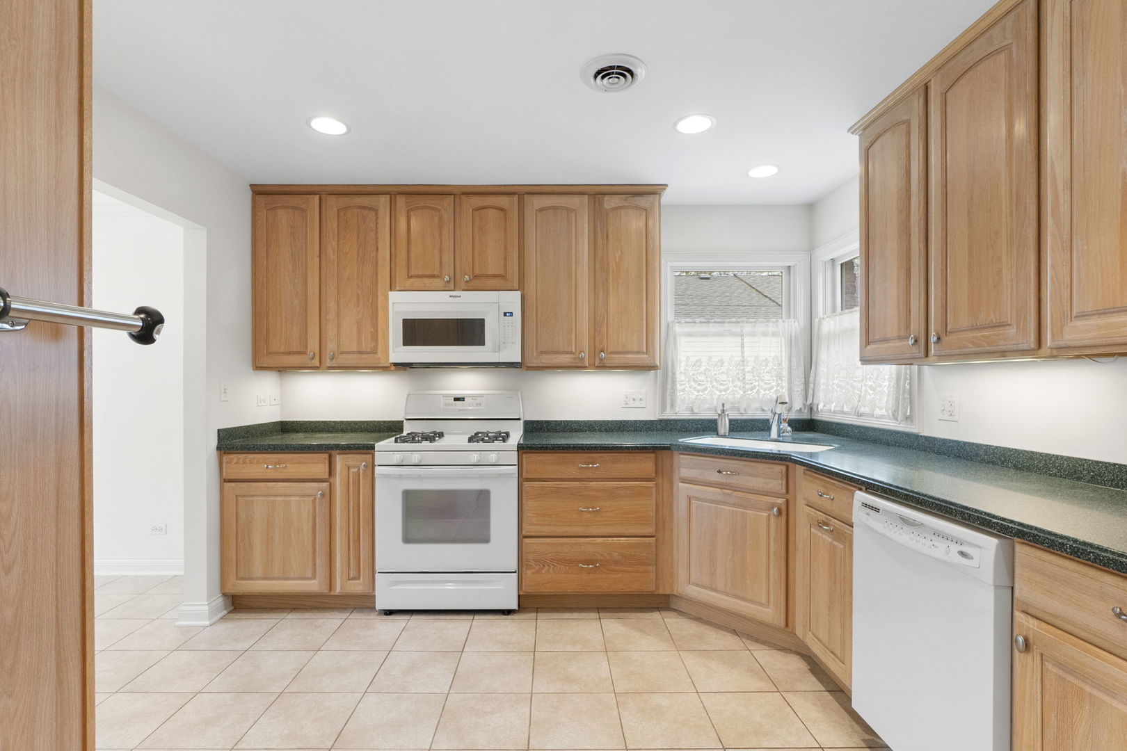 837 East Rockland Road Libertyville, IL 60048 - Photo 2 of 17 a kitchen with stainless steel appliances granite countertop a stove a sink and a microwave