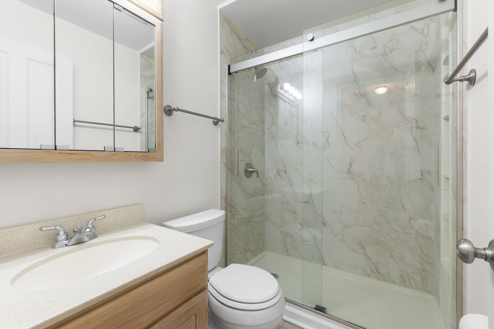 837 East Rockland Road Libertyville, IL 60048 - Photo 6 of 17 a bathroom with a sink a toilet and shower