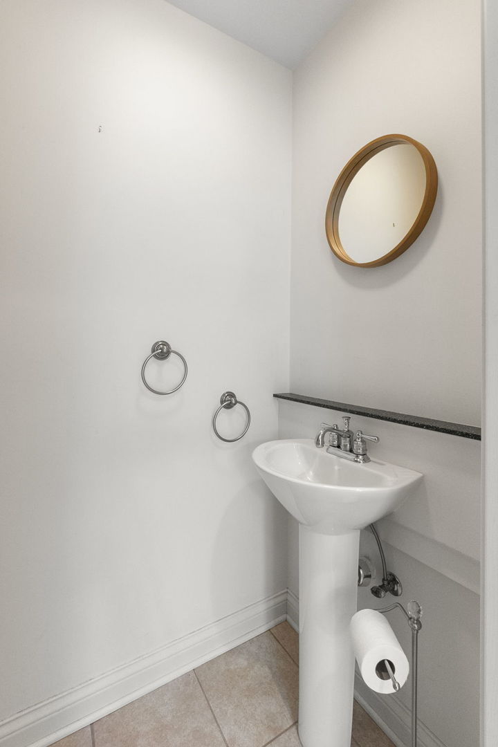 837 East Rockland Road Libertyville, IL 60048 - Photo 7 of 17 a bathroom with a sink mirror and toilet