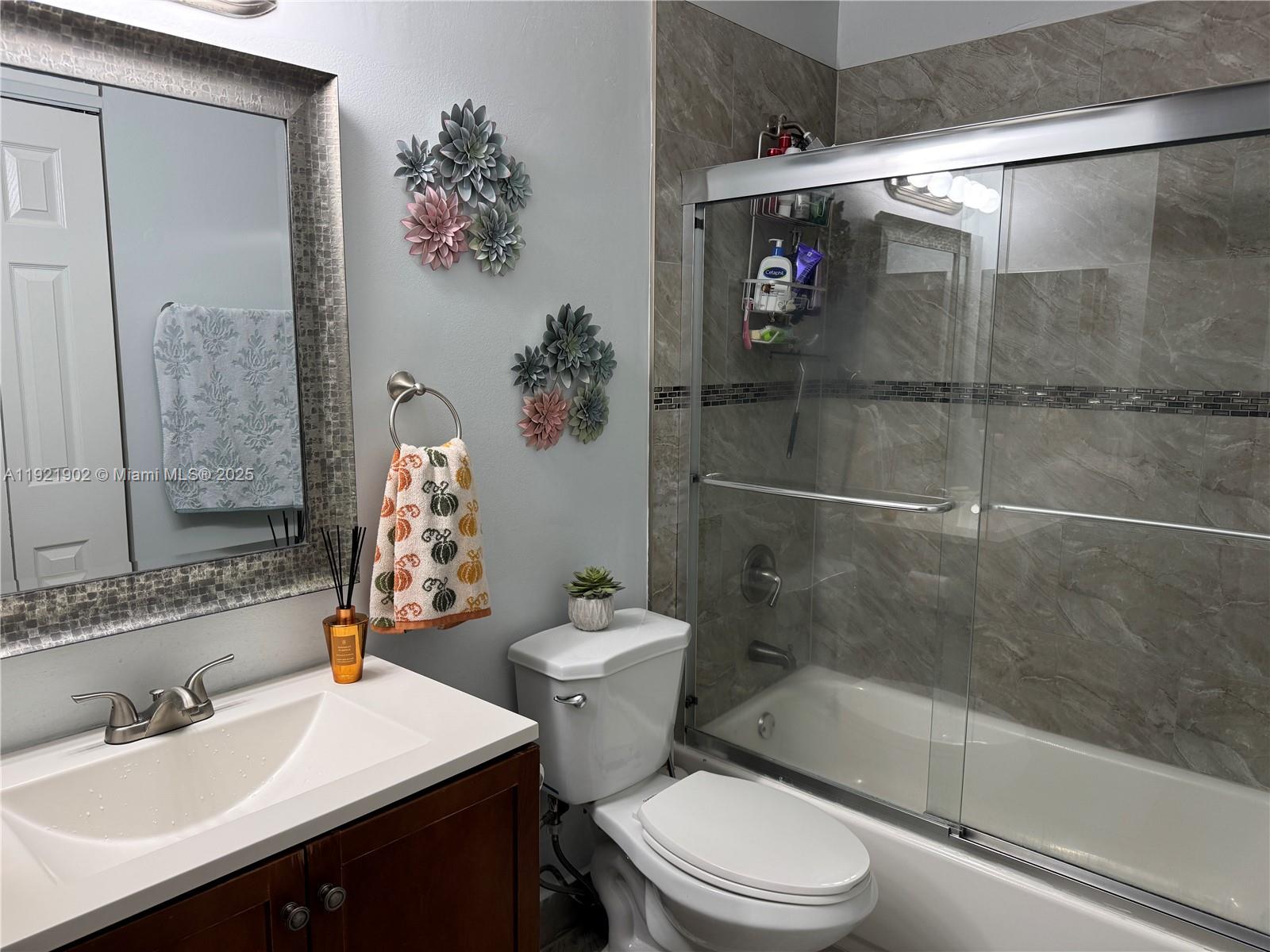 9446 Southwest 140th Court, Unit 9446 Miami, FL 33186 - Photo 11 of 48 a bathroom with a sink toilet and shower
