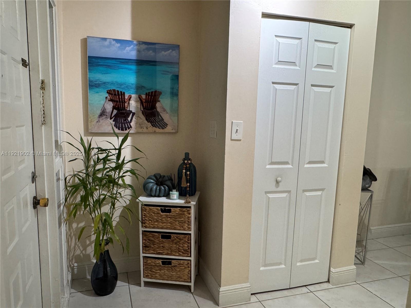 9446 Southwest 140th Court, Unit 9446 Miami, FL 33186 - Photo 13 of 48 a view of a closet and a living room