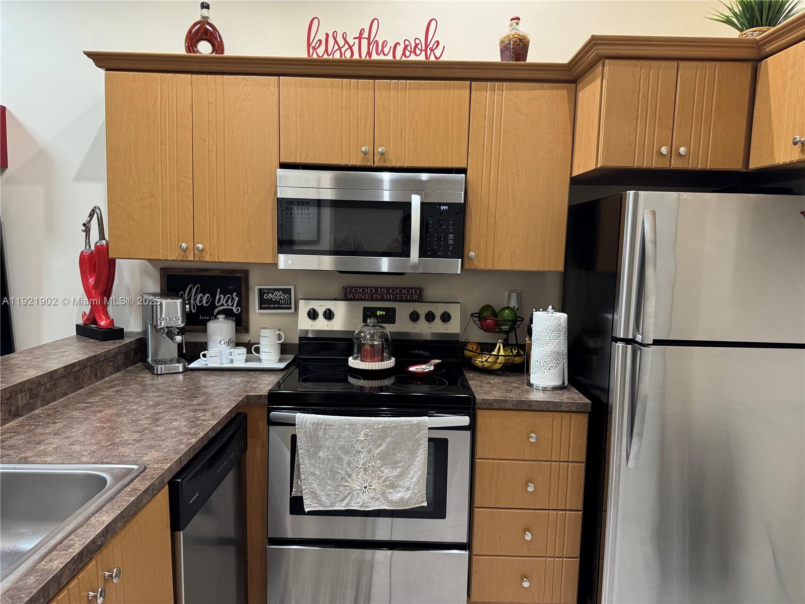 9446 Southwest 140th Court, Unit 9446 Miami, FL 33186 - Photo 2 of 48 a kitchen with a refrigerator and a sink