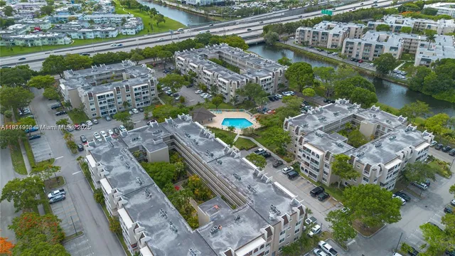 a kitchen with stainless steel appliances kitchen island granite countertop a table and chairs in it
