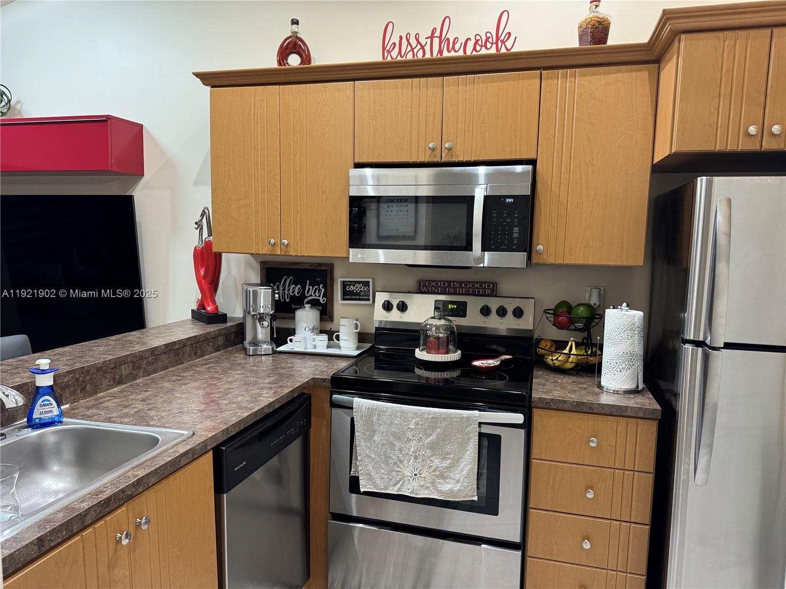 9446 Southwest 140th Court, Unit 9446 Miami, FL 33186 - Photo 35 of 48 a kitchen with a sink stove and refrigerator