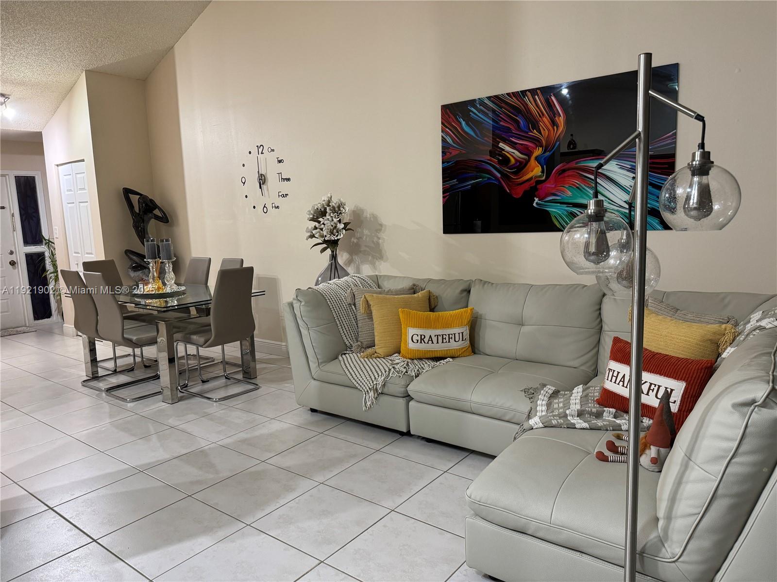 9446 Southwest 140th Court, Unit 9446 Miami, FL 33186 - Photo 4 of 48 a living room with furniture and a flat screen tv