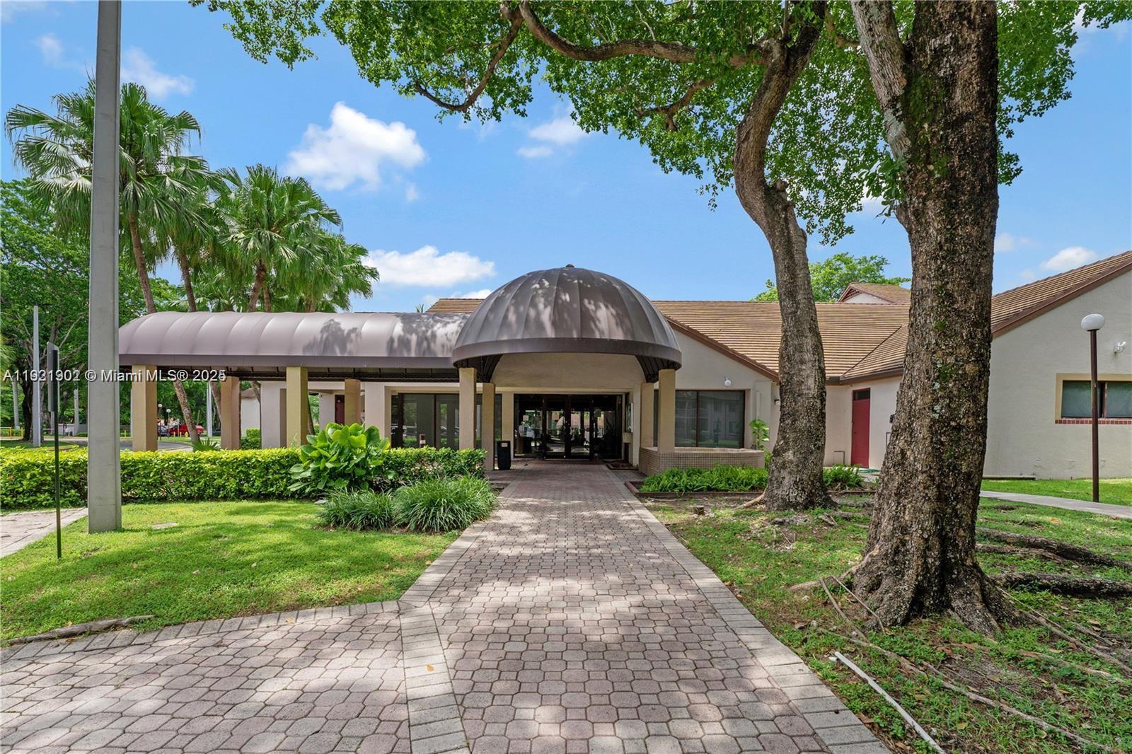 9446 Southwest 140th Court, Unit 9446 Miami, FL 33186 - Photo 47 of 48 a front view of a house with yard and green space