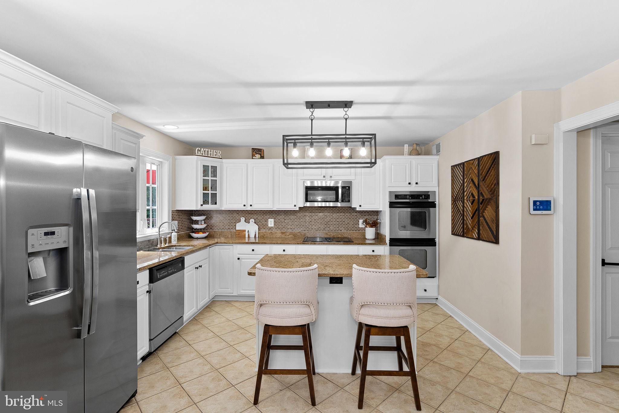 7214 Calamo Street Springfield, VA 22150 - Photo 24 of 77 Island seating and cabinetry