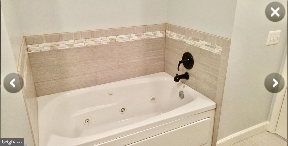 1855 Stratford Park Place, Unit 214 Reston, VA 20190 - Photo 14 of 29 a bathroom with a tub and shower