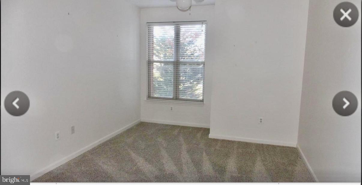 1855 Stratford Park Place, Unit 214 Reston, VA 20190 - Photo 15 of 29 an empty room with windows