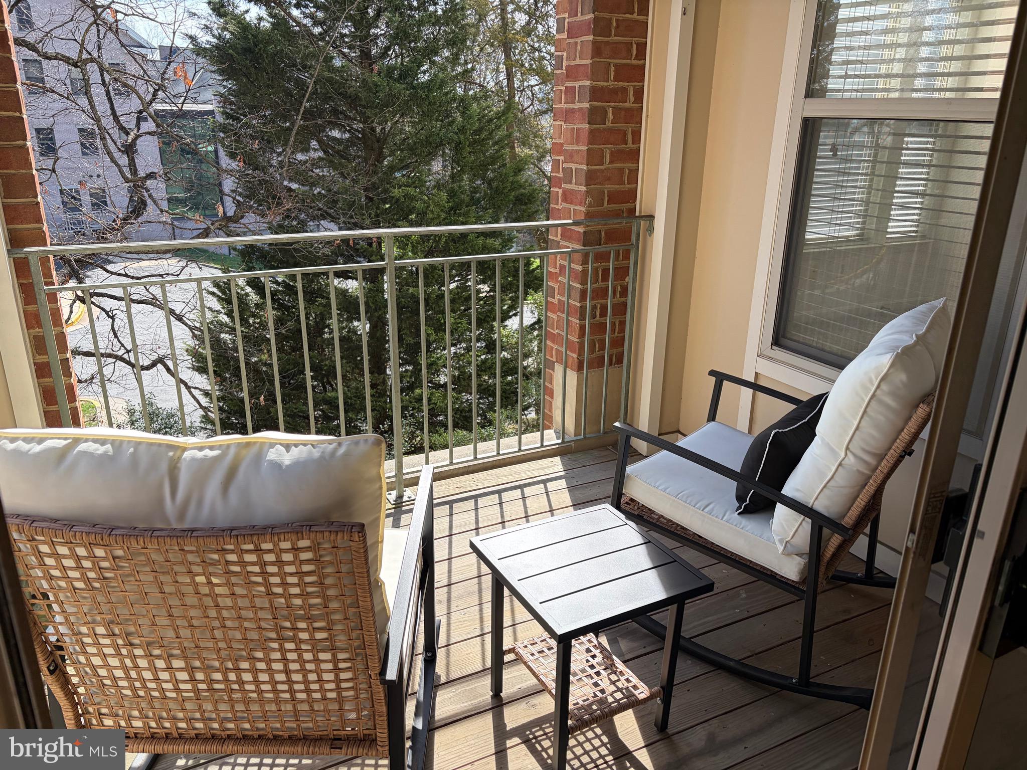 1855 Stratford Park Place, Unit 214 Reston, VA 20190 - Photo 17 of 29 a balcony with wooden floor and outdoor seating